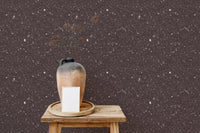 Brown speckled wallpaper featuring a clay vase on a small wooden stool.