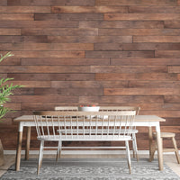 Dining room with a wooden table set against a wooden plank effect wall mural.