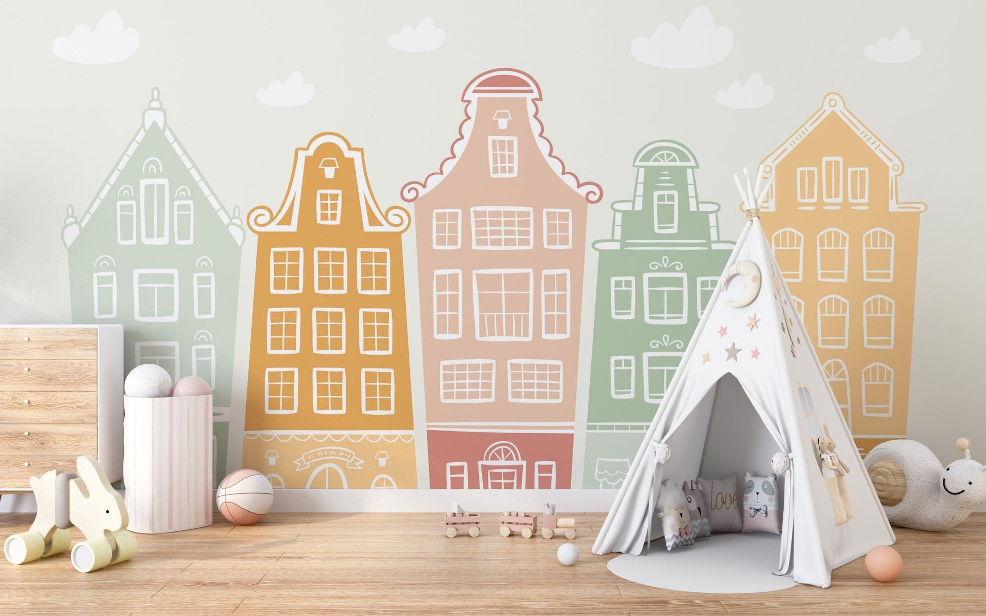 Row of pastel gabled building on a wall mural in a child's room with neutral rug.