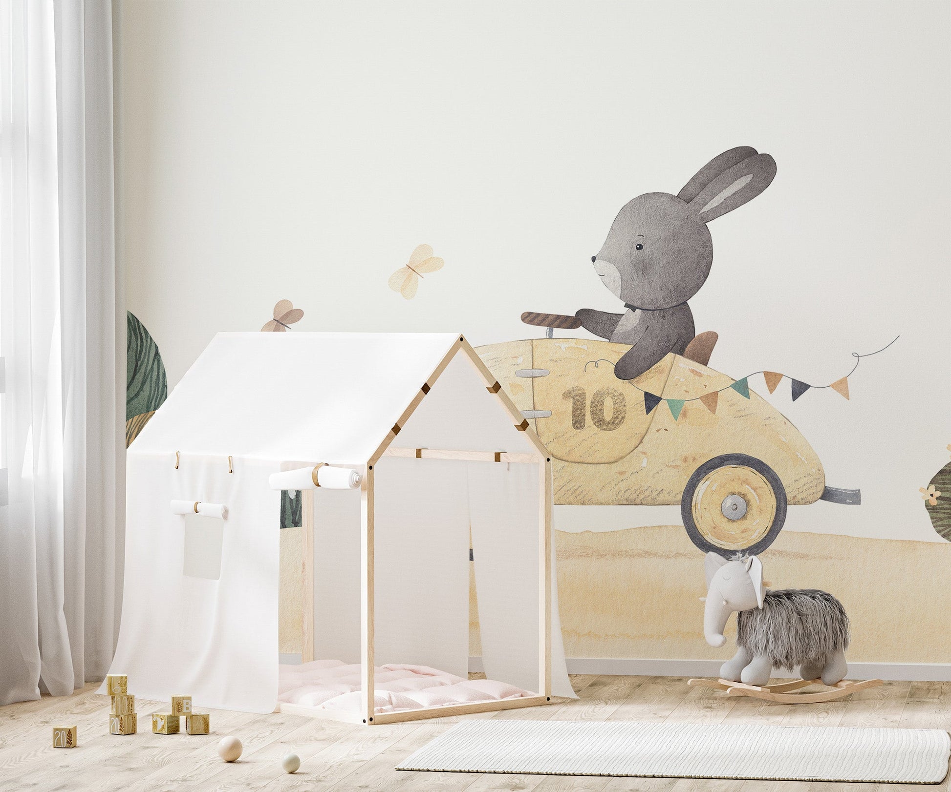 Pastel watercolor bunny racing car wall mural for playful decor.