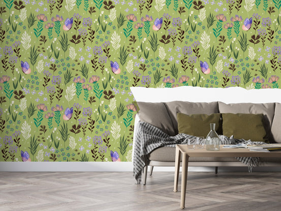 Soft pastel green wall mural displaying a variety of meadow herbs and purple butterflies.
