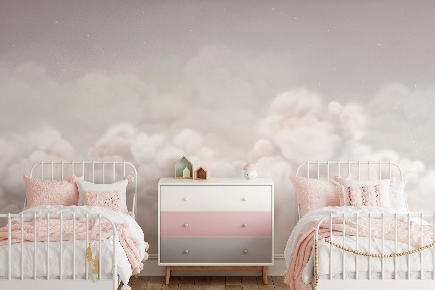 Fluffy pink and white cloud wall mural behind two twin beds in a shared bedroom.