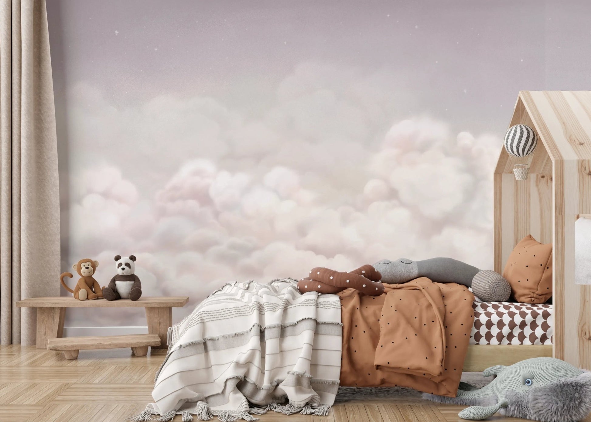 Soft pink sky wall mural in a child's room with a grey patterned rug and toys.