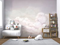 Calming Clouds Pink Wall Mural in a minimalist nursery with a white armchair.