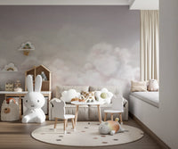 Pink sky themed wall mural in a bedroom with a white bunny chair and round rug.