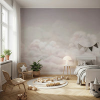 Calming Clouds Pink Wall Mural in a kids bedroom with a wooden bed and wicker chairs.