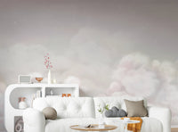 Modern pink cloud wall mural behind a white sofa in a bright living room.