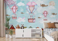 Light blue sky wall mural with city buildings in a minimalist kids' bedroom.