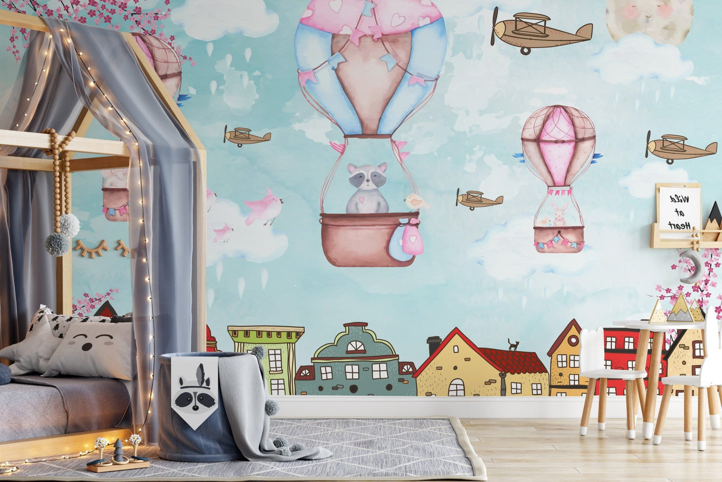 City skyline wall mural with illustrated houses for a children's sleeping area.