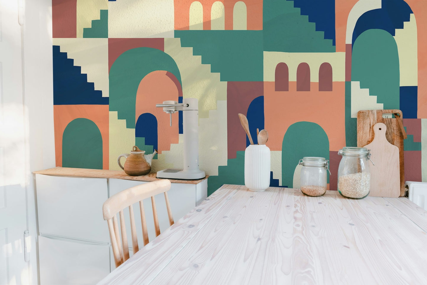 Vibrant kids cartoon wall mural behind jars in dining room.