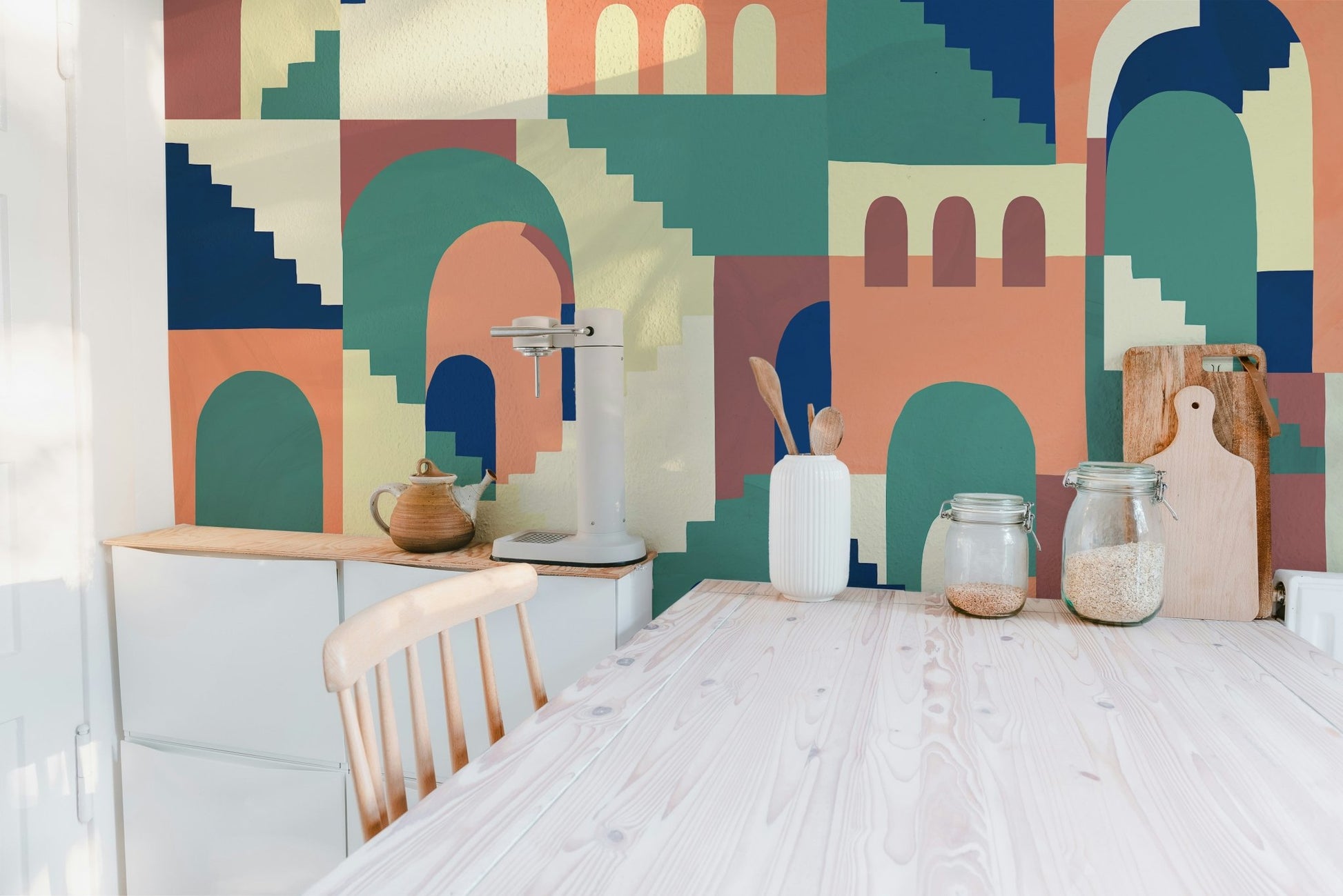 Vibrant kids cartoon wall mural behind jars in dining room.