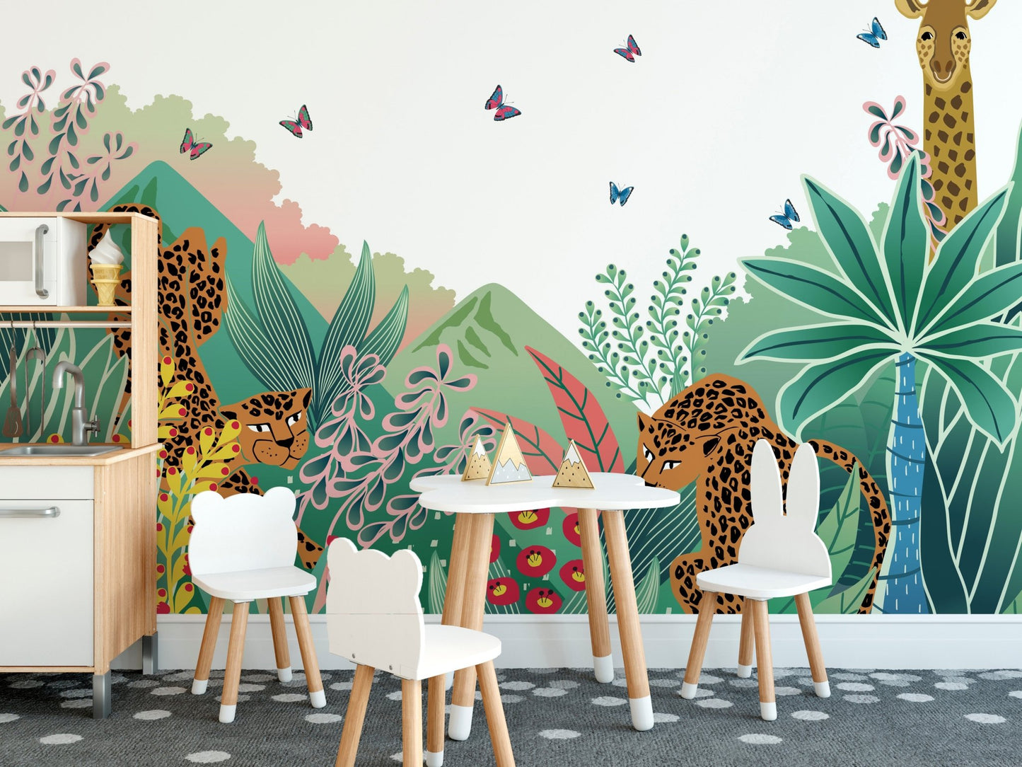 Green jungle safari wall mural in a dining space with a small white desk and chairs.