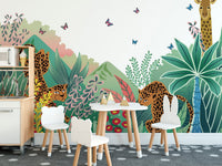Green jungle safari wall mural in a dining space with a small white desk and chairs.