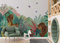 Cartoon Safari Tales wall mural in a modern room with a green armchair and toy horse.