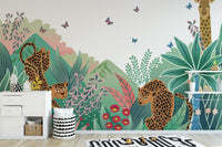 Cartoon Safari Tales wall mural with leopards and giraffes in a bright nursery.