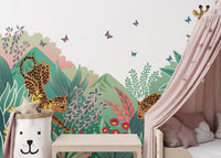 Pastel jungle safari wall mural partially covered by a pink bed canopy in a bedroom.