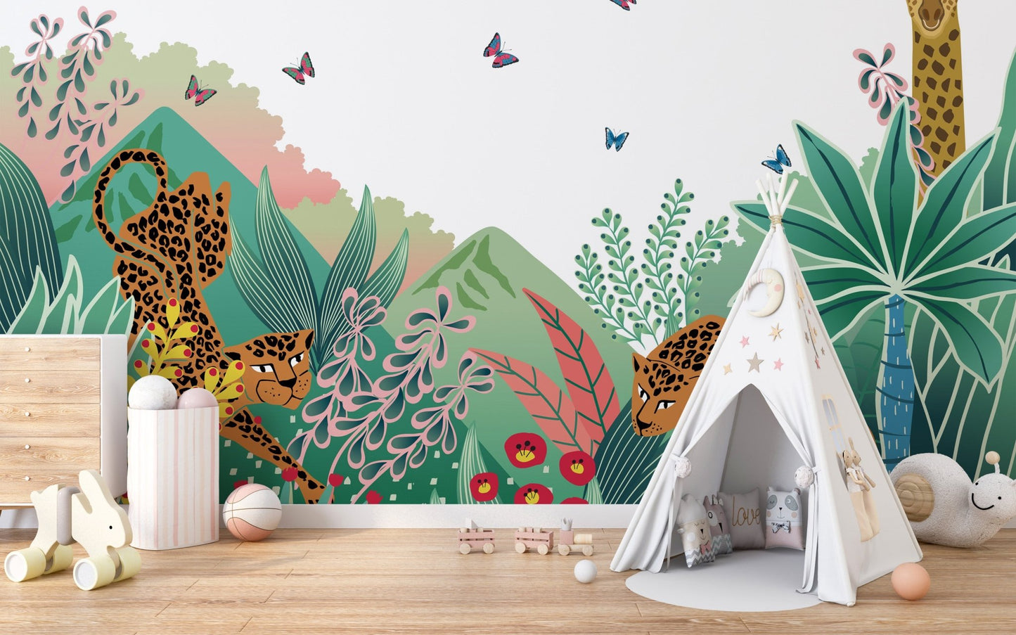 Cartoon Safari Tales wall mural behind a white teepee tent in a soft play area.