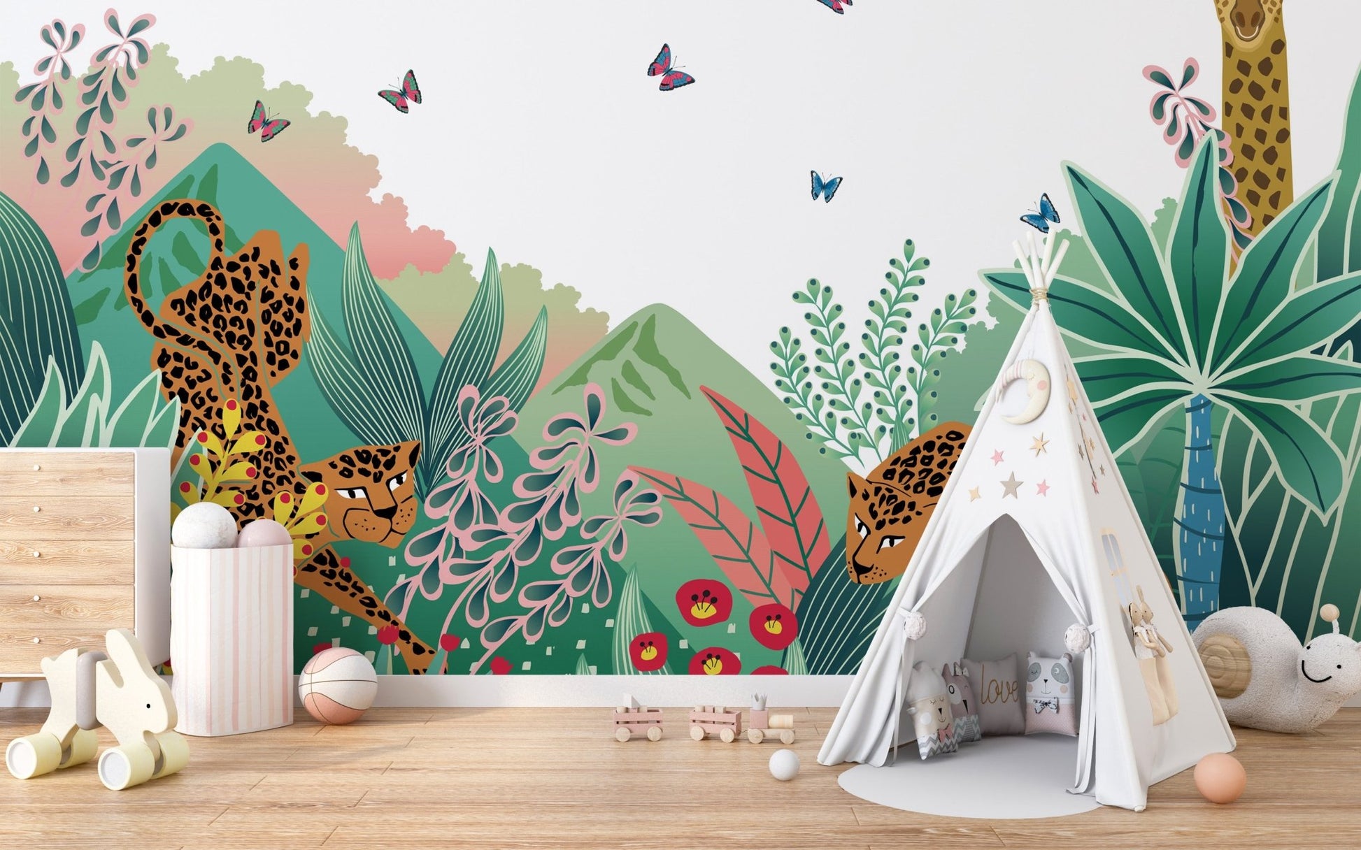 Cartoon Safari Tales wall mural behind a white teepee tent in a soft play area.