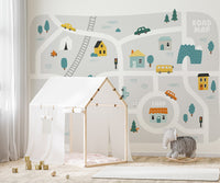 Illustrated road map wallpaper mural with buildings and forest details.