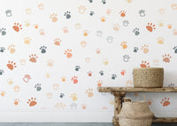 Cat paw repeat pattern wallpaper installed in a room with wicker storage baskets.