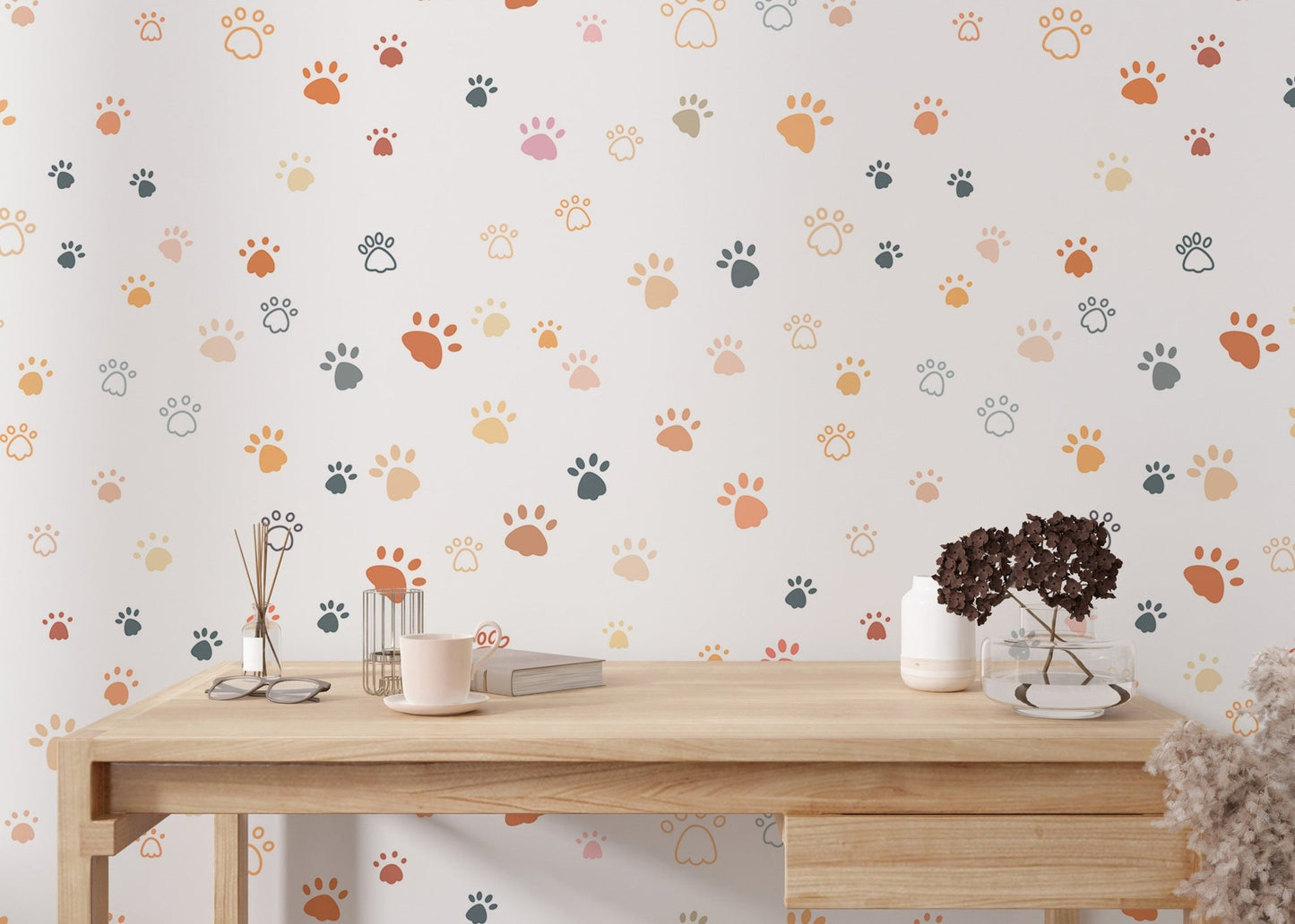 Minimalist paw print wallpaper on a study room wall with a light wood desk.