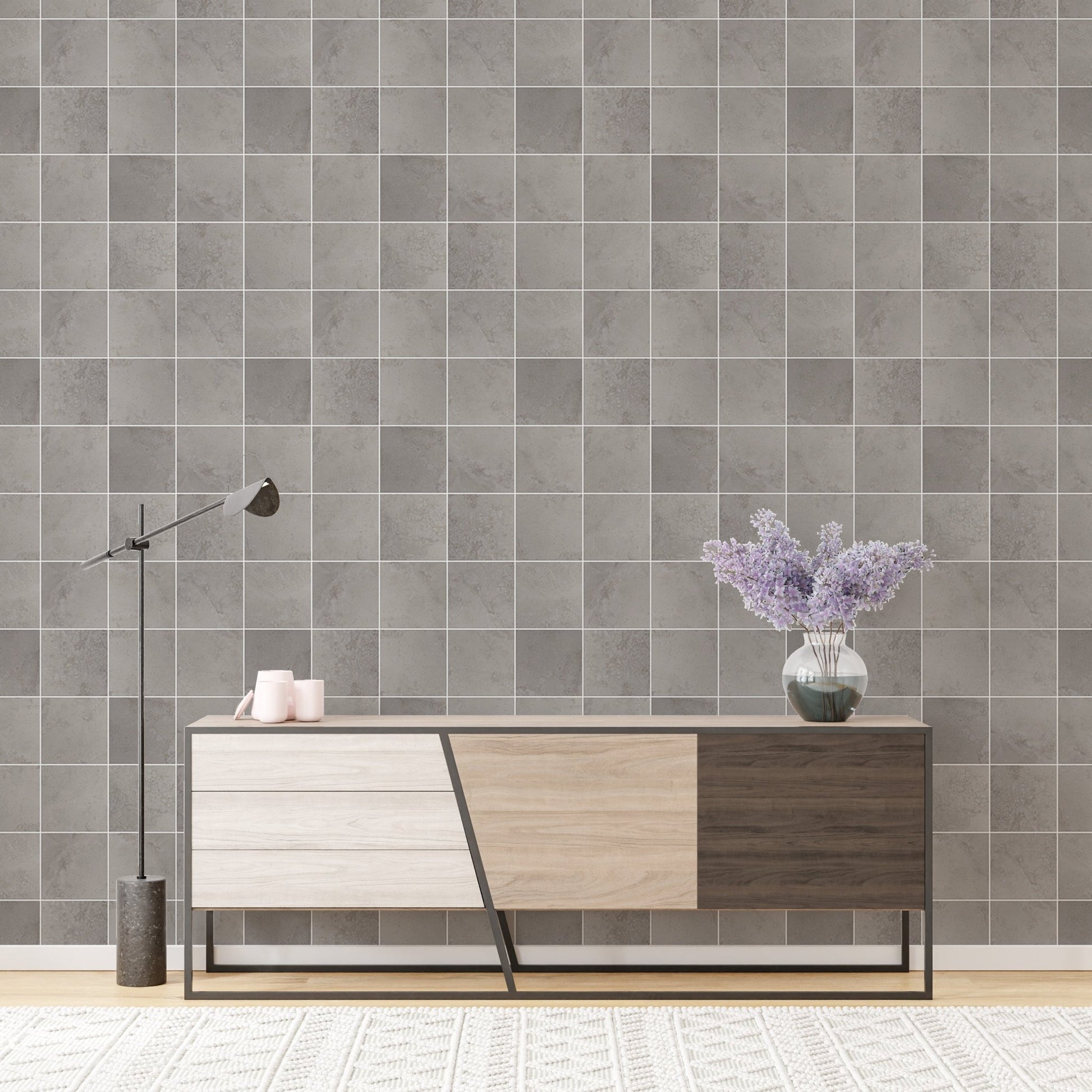 Minimalist grey tile wallpaper behind a modern wooden sideboard.