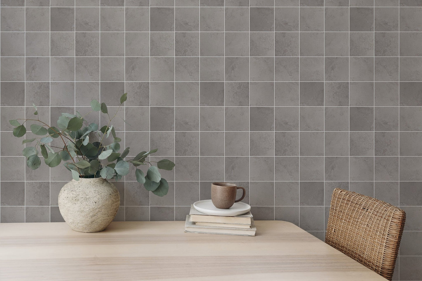 Neutral grey tile wallpaper behind a light wood dining table.