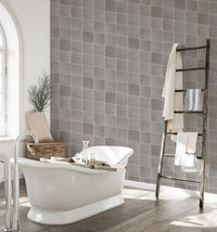 Ceramic grey color tiles seamless pattern wallpaper in a bathroom.