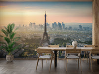 Stylish dining area with a scenic Paris skyline mural backdrop.