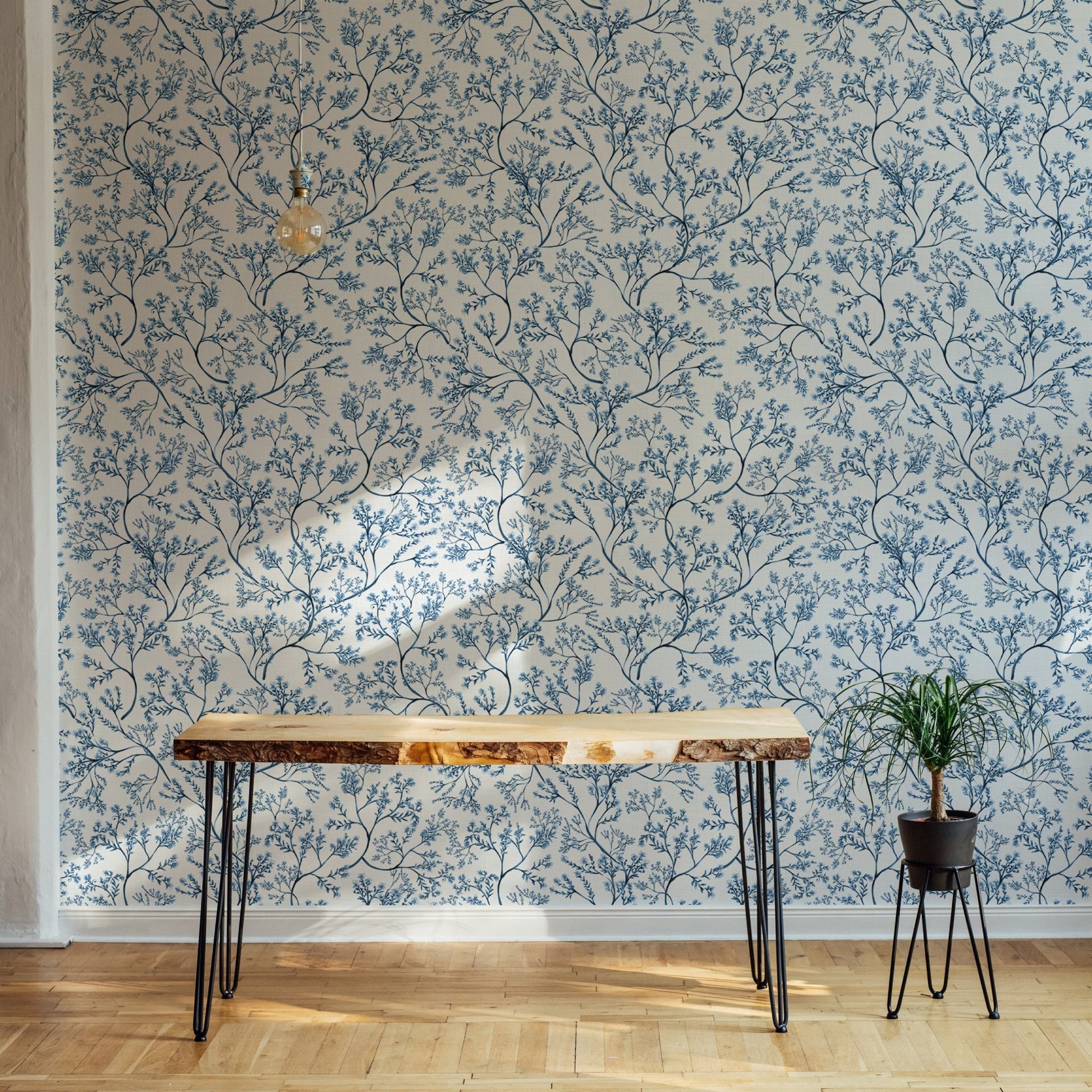 Classic nostalgic botanical wallpaper behind a live edge wooden table