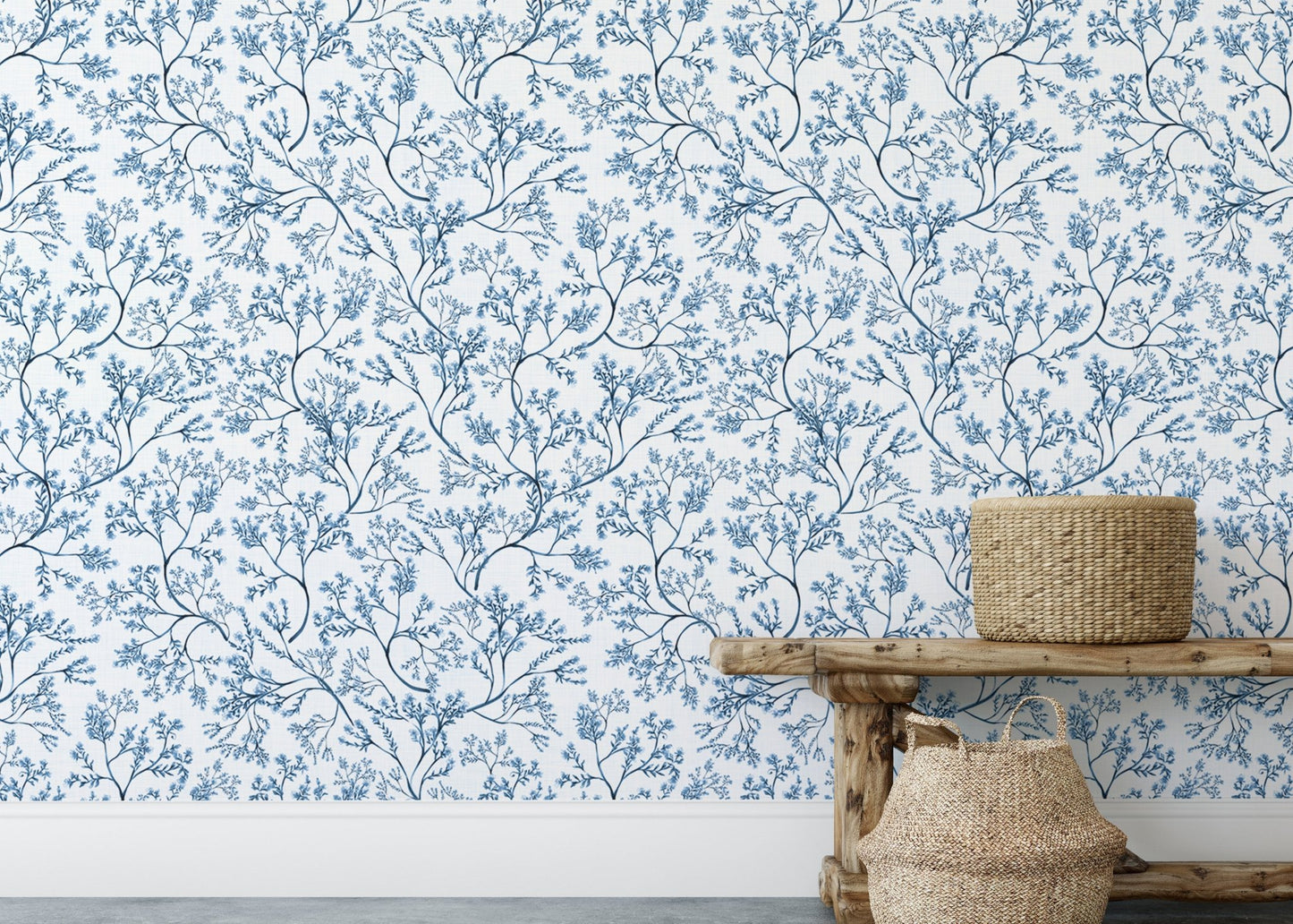 Chinoiserie wild flower wallpaper behind a wooden bench and baskets