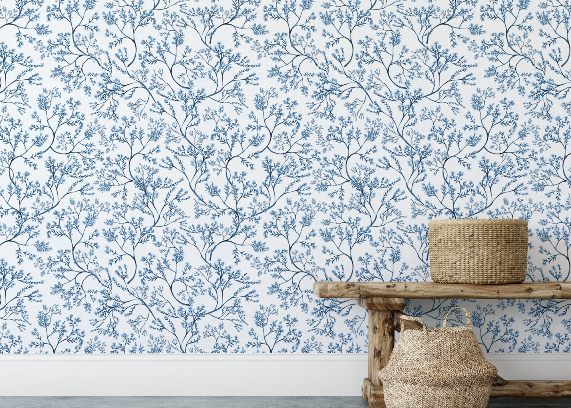 Chinoiserie wild flower wallpaper behind a wooden bench and baskets