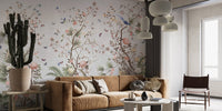 Artistic wall mural with blue birds and pink flowers in a sunlit room.