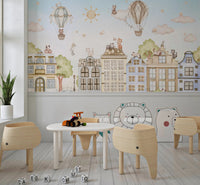 Classroom wall mural with cat illustrations and a small white activity table.