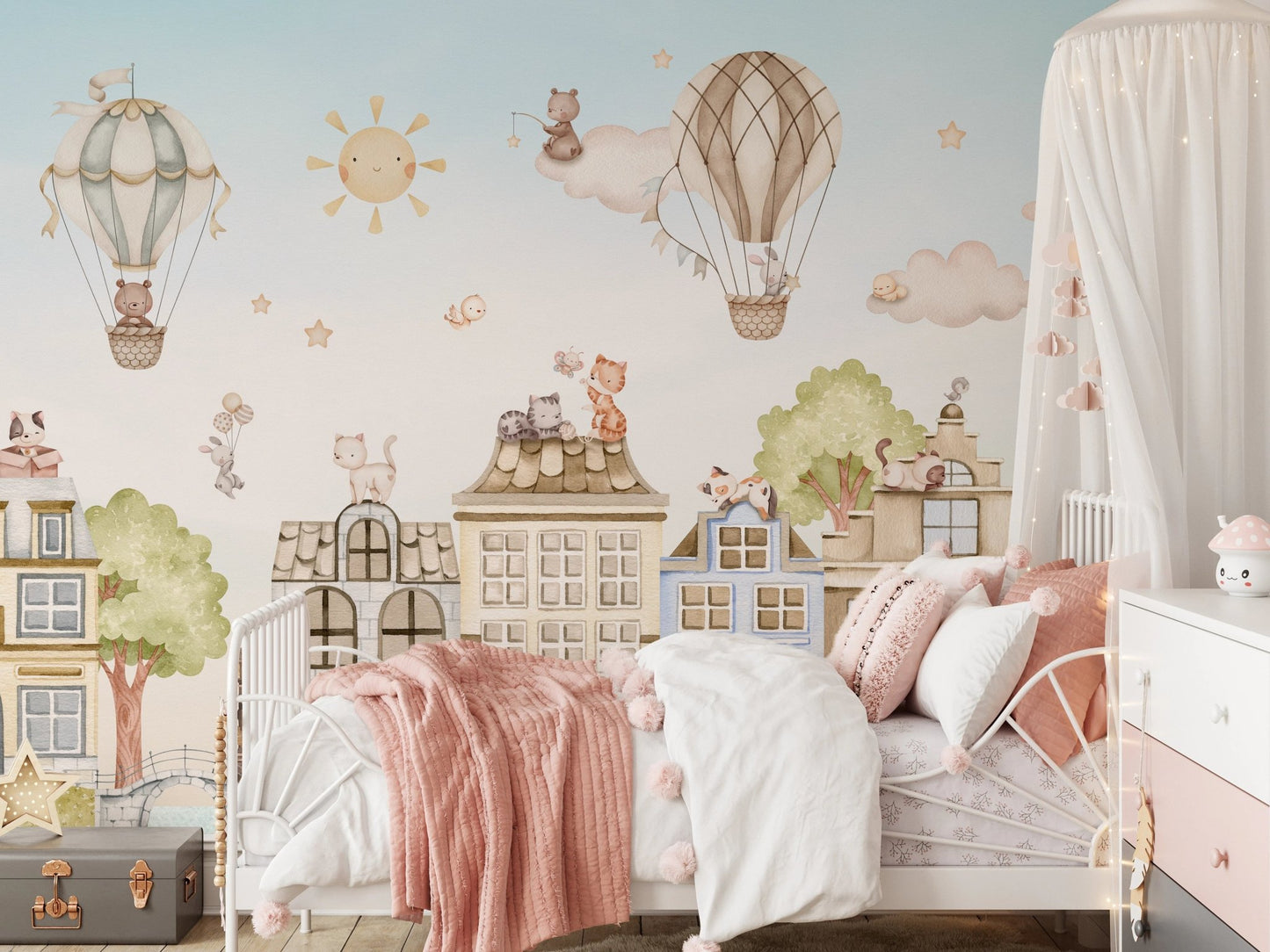 City Cats Wall Mural behind a white bed with pink linens in a nursery.