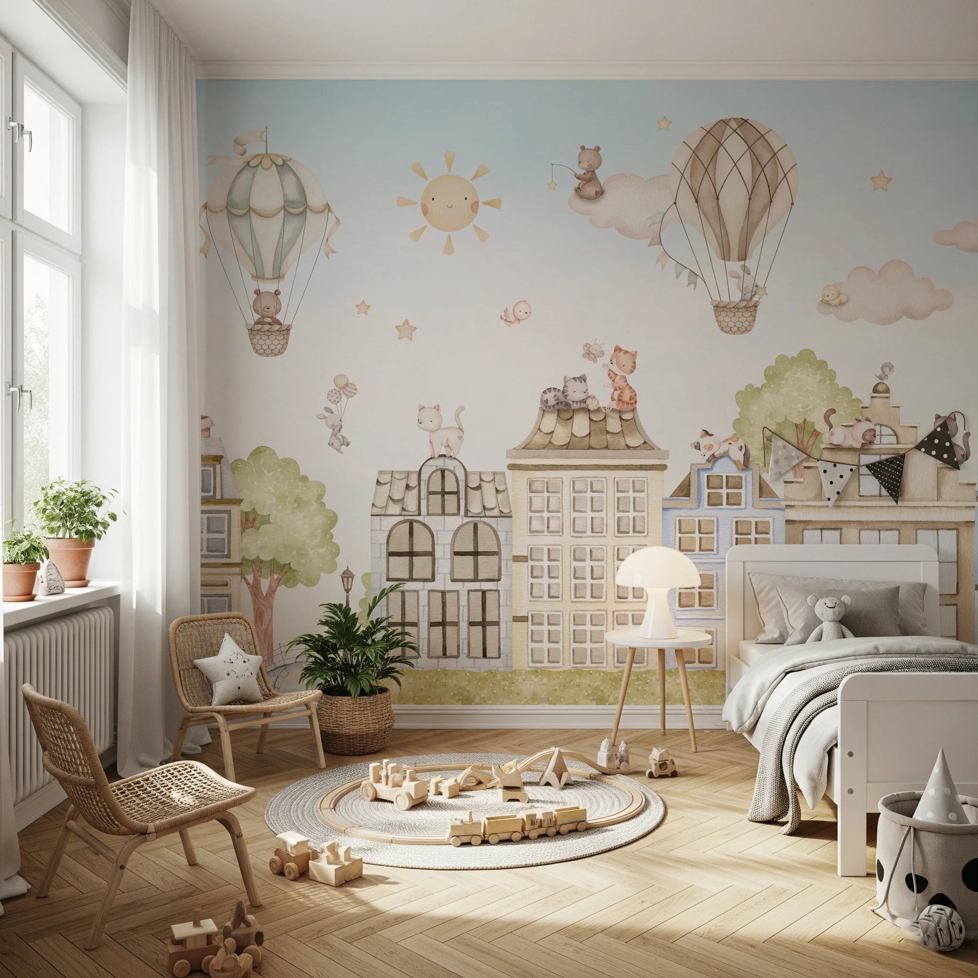Kids bedroom wall mural with cats sitting on roofs and a sun illustration.