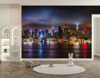 Modern urban city skyline wall mural in a nursery with a round white rug.