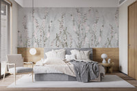 Minimalist bedroom featuring white bedding and floral mural on a grey wall.