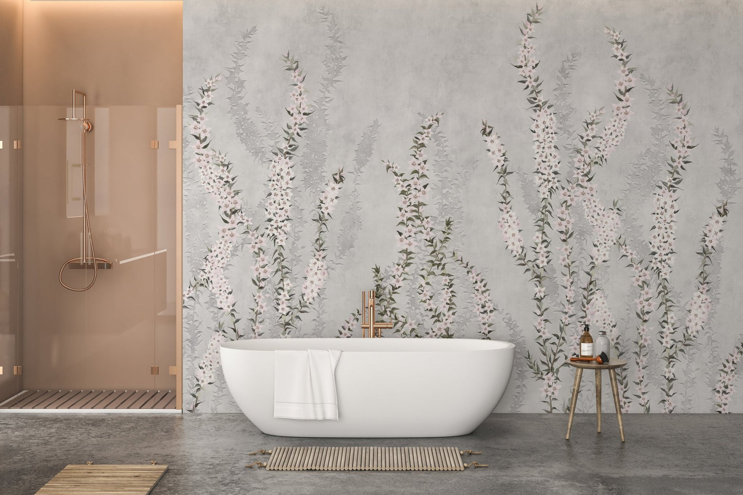 White bathtub against grey floral branch wall mural in a modern bathroom.
