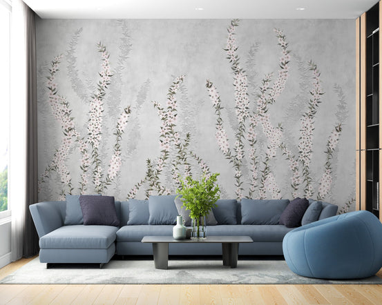 Blue sectional sofa in a modern living room with floral branch wall mural.