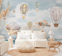 Muted color airship drifting above grey peaks wall mural