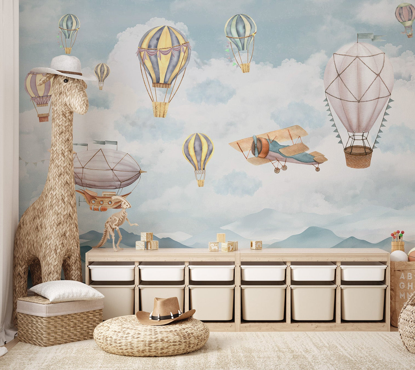 A peaceful flight of balloons mural with airships over cloud-covered mountains.