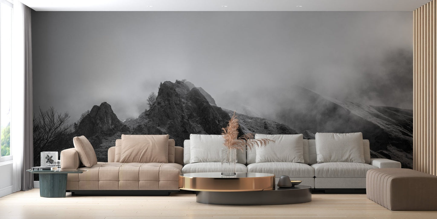 Living space featuring misty mountain peaks wall mural and a tan leather sofa.