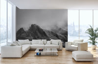 Minimalist living room featuring grey mountain wall mural and a white sectional sofa.