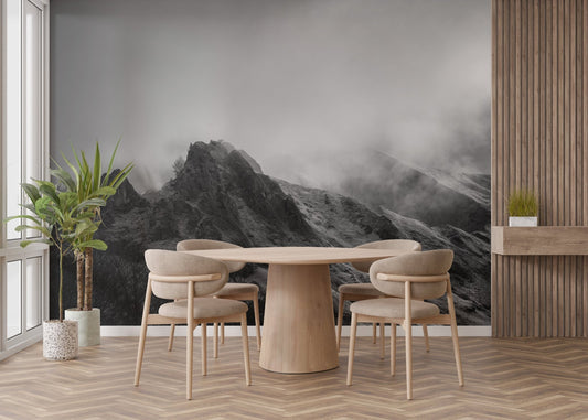 Contemporary dining room with mountain landscape wallpaper mural and black accents.