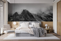 Modern bedroom with Cloudy Skies Over the Peaks Wall Murals behind a grey bed.