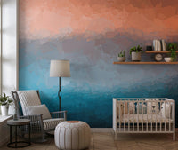 Neutral nursery room with a soft coral and blue coastal wall mural
