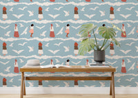 Flying seagull wallpaper behind a long wooden console table with a plant.