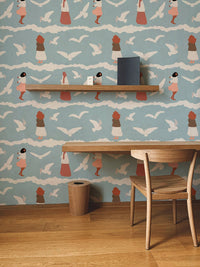 Kids study space wallpaper with bird motifs behind a wooden desk and chair.