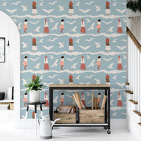 Blue seagull wallpaper behind a black metal shelf in a bright hallway.